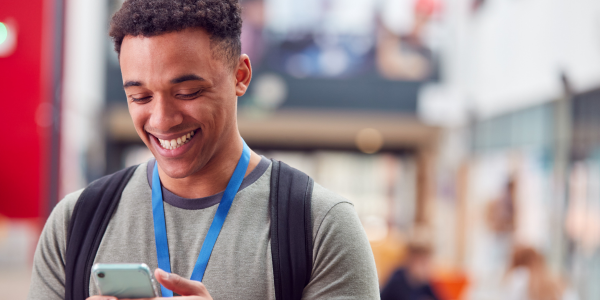 happy college student on cell phone