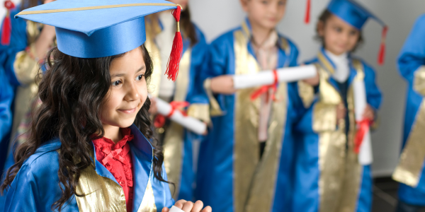 PreK and Kindergarten Graduation Gift ideas - young graduates in cap and gowns