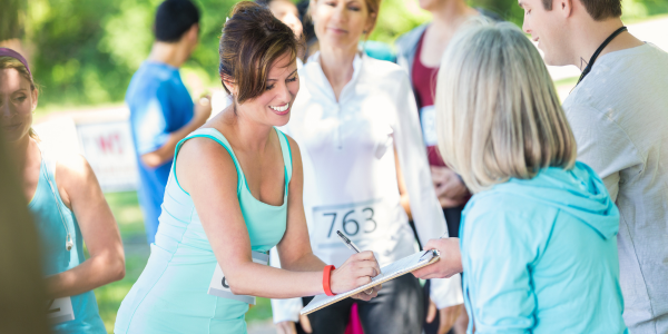 Spring Fundraiser Ideas - woman signing in for a 5K fun run