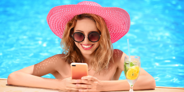 woman in pool on her phone, planning an event with SignUp